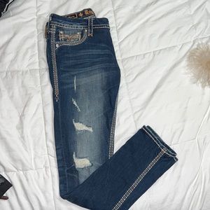 Rock revival ripped with patches skinny jeans.